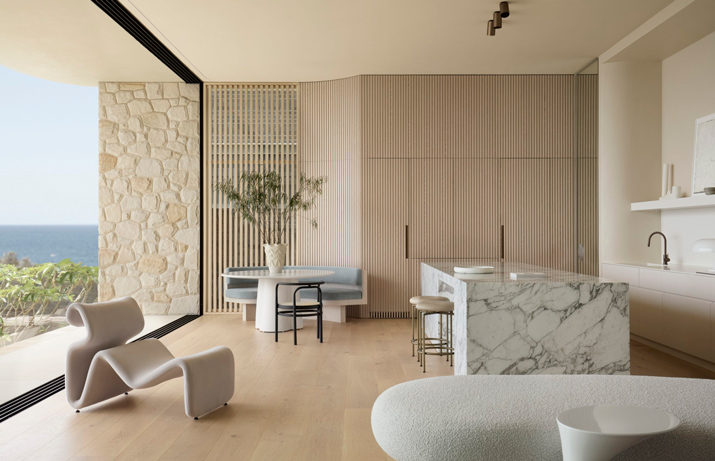 An open-plan living and dining room looking out to the sea