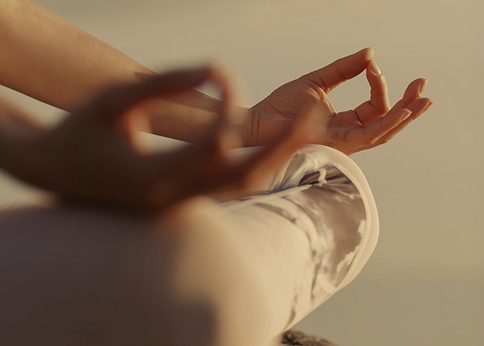 Hands resting in a meditation pose
